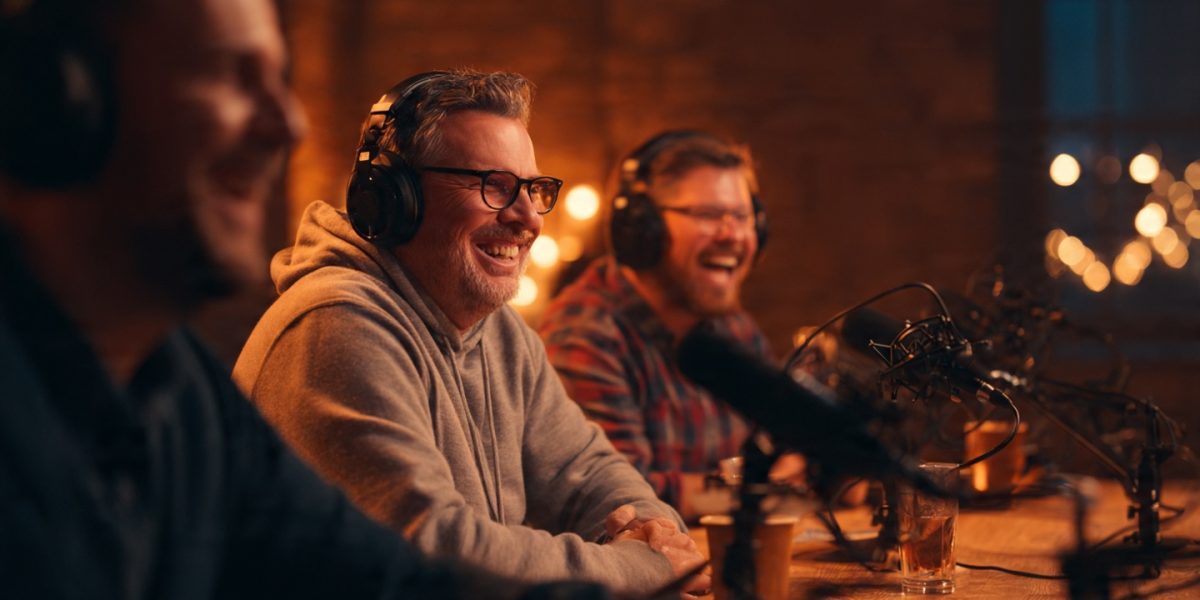 a_group_of_three_podcasters_laughing_together